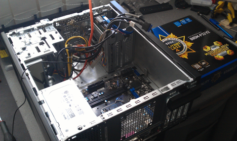 motherboard being installed into a computer case by a computer repair expert in Stevenage near hitchin letchworth welwyn garden city hatfield baldock codicote woolmer green hertford bengeo ware knebworth