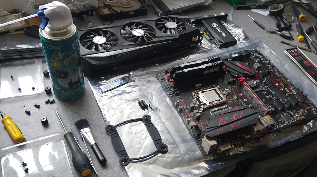 This picture shows an old gaming tower computer motherboard being replaced for a newer model and installed into a gaming tower p c at a computer motherboard upgrade shop in stevenage near hitchin letchworth baldock welwyn garden city hatfield hertford knebworth north herts